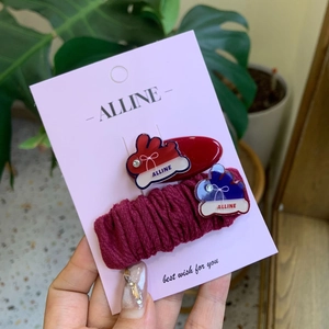 Cute bunny hair clips set with red and burgundy bows on a display card for girls