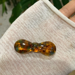 Macro shot of a handmade tortoiseshell acetate bow hair clip with France engraving