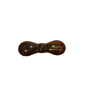 Amber acetate bow hair clip with gold France Handmade logo on a white background