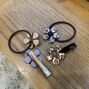 Detailed set of floral hair ties and clips featuring leopard print patterns and rhinestones
