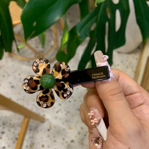 Elegant leopard print flower hair clip with rhinestones and green bead center