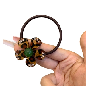 Handheld leopard print flower hair tie with green bead and sparkling rhinestones
