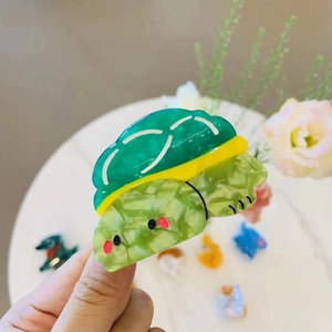 Cute turtle acetate hair claw clip with emerald green and yellow tortoiseshell pattern