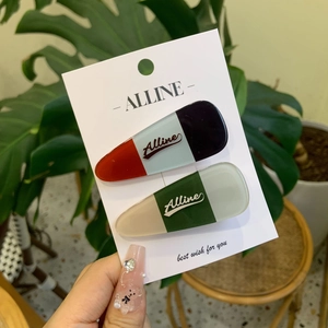 Detail view of Alline color-block hair clips in red, blue and green on display card