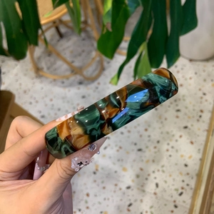 Elegant acetic acid hair clip with dark green marble pattern in a daily life scene