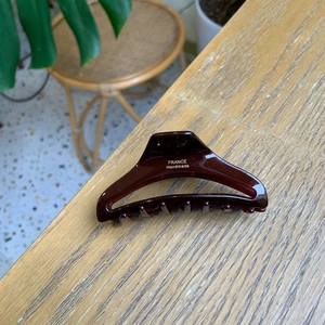 Detail of dark brown tortoiseshell hair claw with France Handmade inscription on wood