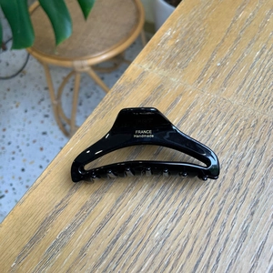 Detail view of the elegant black hair claw clip with golden France Handmade logo engraving