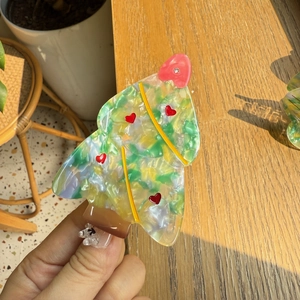 Christmas tree shaped acetate claw clip with colorful marble pattern and heart details