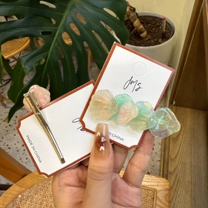 Détails macro de barrettes coquillages au fini nacré et structure en métal à l'arrière