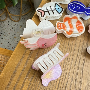 Various cute ocean-themed acrylic hair claws featuring jellyfish and fish shapes