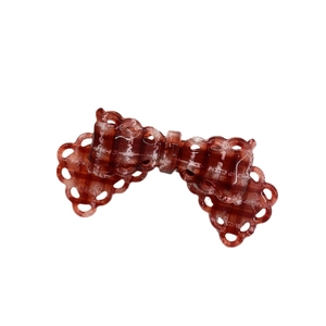 Elegant amber acetate bow hair clip with lace cutout edges and houndstooth pattern print