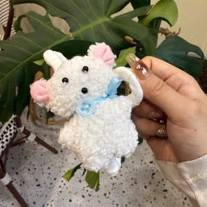 Plush white fleece puppy hair claw clip with blue ribbon bow and button detail