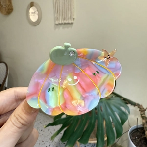 Colorful acetate scallop hair claw with marble texture and cute pumpkin design