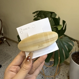Elegant cream yellow marble acetate oval hair barrette on a branded display card