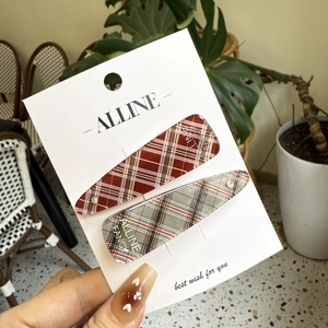 Set of two red and grey plaid hair clips with rhinestones for women on brand card