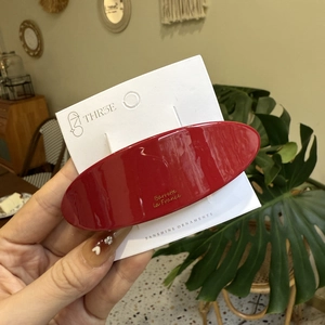 Glossy red oval acetate hair clip for women with French style lettering on display card