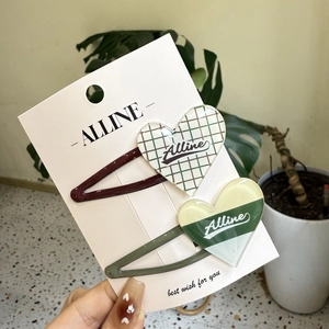 Minimalist heart hair clips with leopard print and plaid patterns on display card