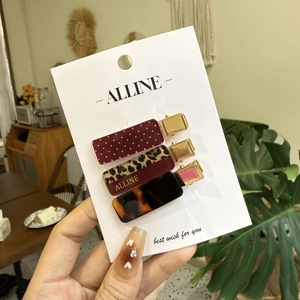 Three-piece set of stylish hair clips featuring polka dot, leopard, and amber shell patterns