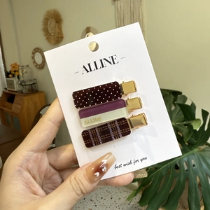 Three-piece set of sweet checkered and polka dot hair clips for women on a display card