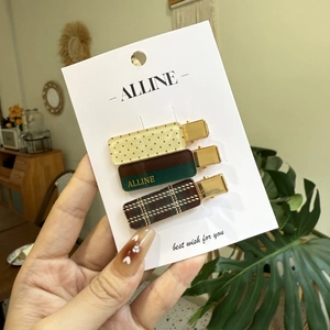 Three-piece set of stylish hair clips with polka dots and plaid patterns on card