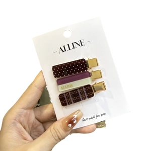 3-piece vintage hair clip set with polka dot, checkered, and purple patterns on gold metal