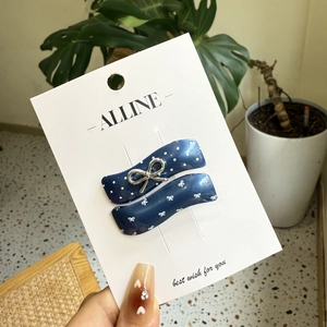 Set of two navy blue wave hair clips with white polka dots and silver metal bow accents