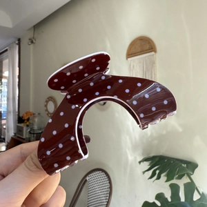 Classic dark brown hair claw clip with white polka dots in a retro cloud shape style