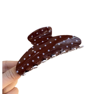 Brown resin hair claw clip with vintage white polka dot pattern and glossy finish