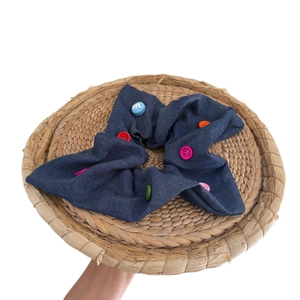 Blue denim scrunchie with colorful candy buttons and white M letter embroidery