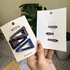 Detail shot of vintage plaid and solid color hair clips on professional display cards