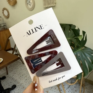 Three-piece set of triangular hair clips in deep burgundy, plaid, and solid grey colors