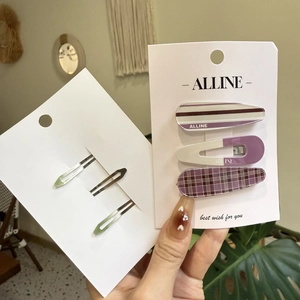 Detailed set of three purple plaid and striped BB hair clips on a white display card