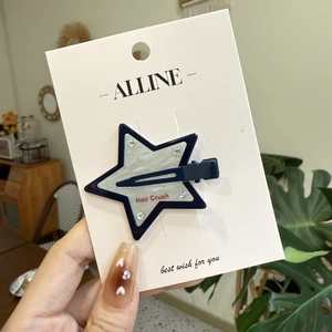 Elegant star-shaped hair clip with navy blue border and rhinestone accents on card