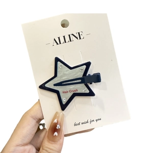 Star-shaped hair clip with navy blue frame, pearly inlay and sparkling rhinestones