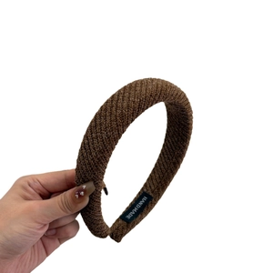 Retro brown knit sponge headband with handmade label and high top textured fabric