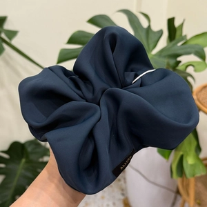 Navy blue oversized silk scrunchie with matte texture and gold ALLINE tag