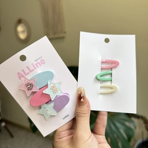 Detailed view of colorful star-shaped hair clips with cute cartoon bear patterns