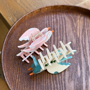 Elegant bird-shaped acetate hair claw clips in blue and pink for stylish high ponytails