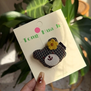Handmade fabric hair clip featuring cute dark green plaid bear with yellow flower