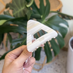Handmade hollow triangular hair claw clip in cream marble pattern for high ponytail styles
