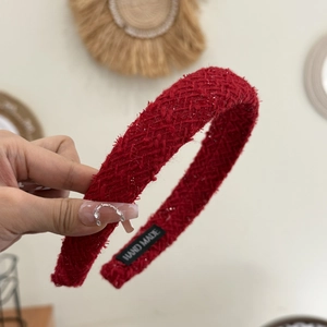 Detail of red plaid tweed headband with gold thread and HAND MADE label on inside band