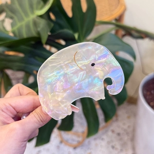 Detailed close-up of elephant-shaped hair claw clip made of iridescent acetate material
