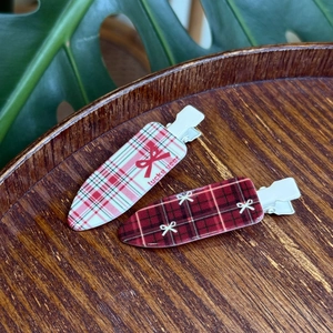 British style red plaid hair clips set with lucky bow pattern on dark wooden tray
