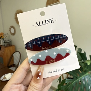 Sweet plaid and polka dot oval hair clips set with red wavy edges on display