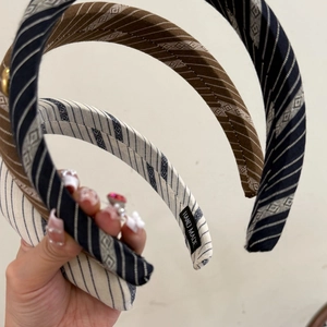 Close-up of handmade jacquard striped headbands with heart pattern in multiple colors