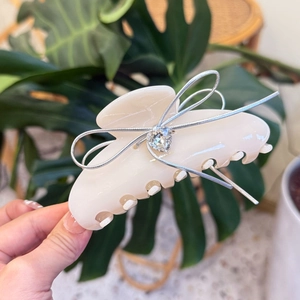 Elegant cream acetate hair claw clip with silver ribbon bow and heart rhinestone accent