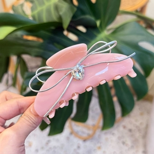 Pink acetate hair claw clip with silver ribbon bow and sparkling heart crystal detail