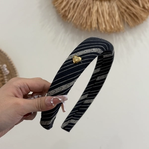 Striped navy and white fabric headband featuring a gold heart ornament for women