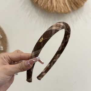 Brown plaid fabric headband with a gold Love engraved metal tag for autumn fashion