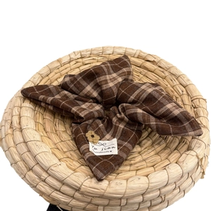Brown plaid fabric scrunchie with a large bowknot and small flower on a woven base